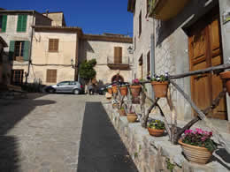 valldemossa street with colourful plant pots